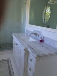 Custom vanity and medicine cabinet with leg details and side panels