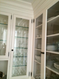 Custom walk–in plate storage with glass doors - Holmby residence