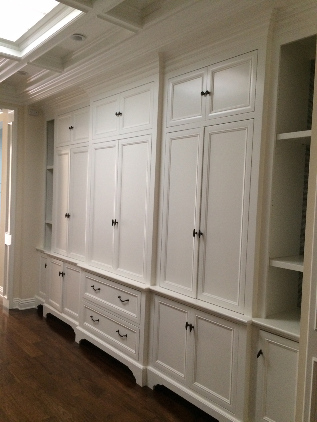 Custom linen closet with custom leg detail and beam & crown at ceiling